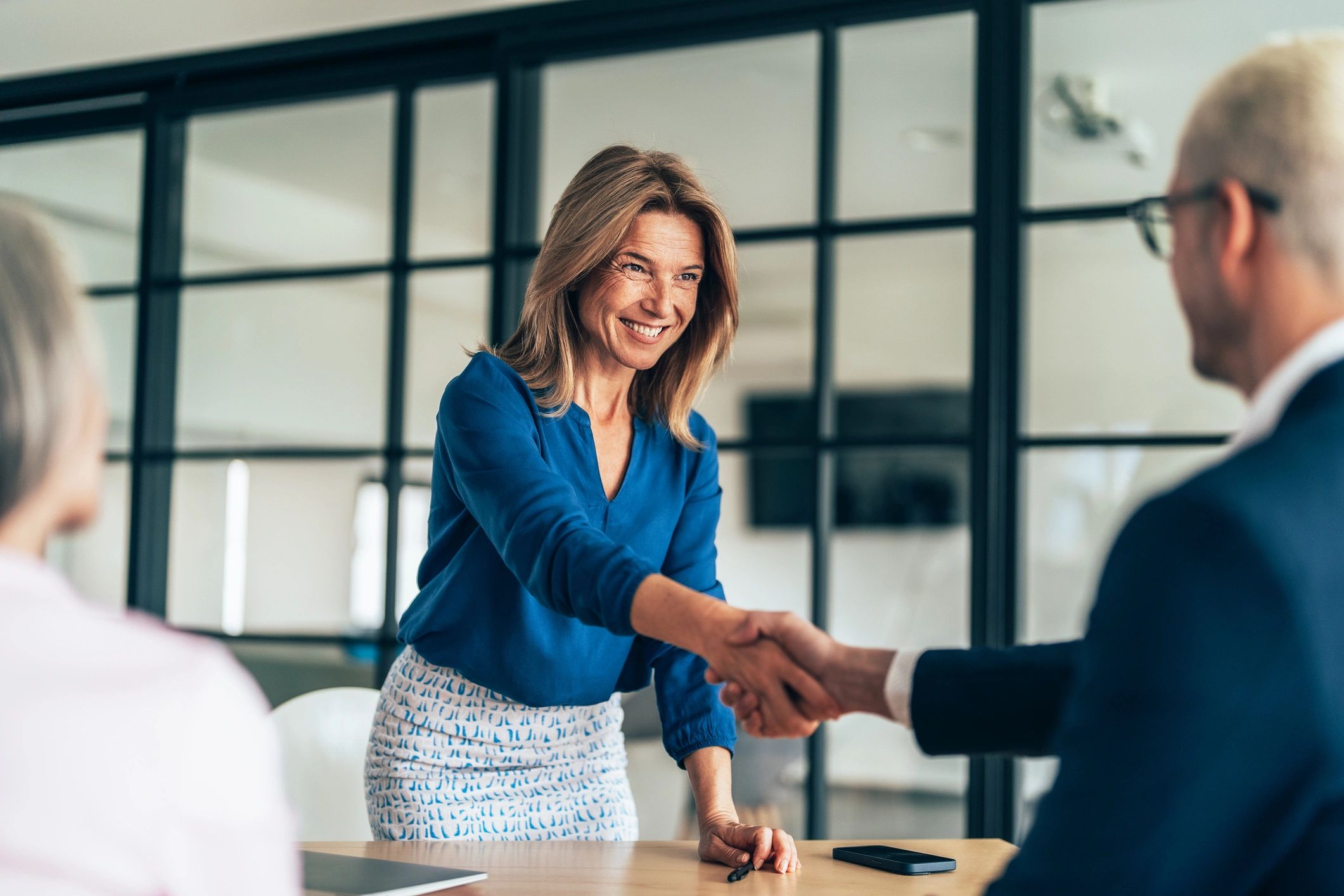 Real estate investor handshake after home sale